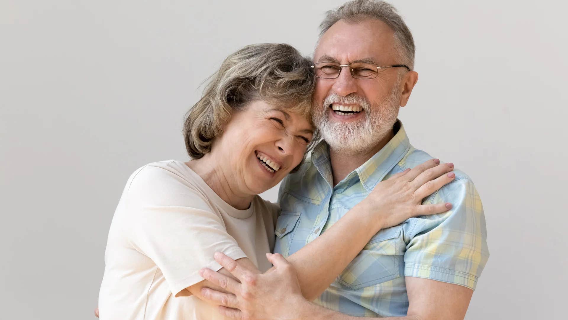 happy older couple smiling hugging each other