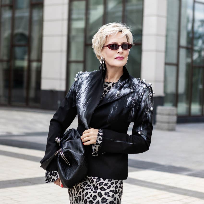woman pretending to be rich wearing fake designer clothes and bag