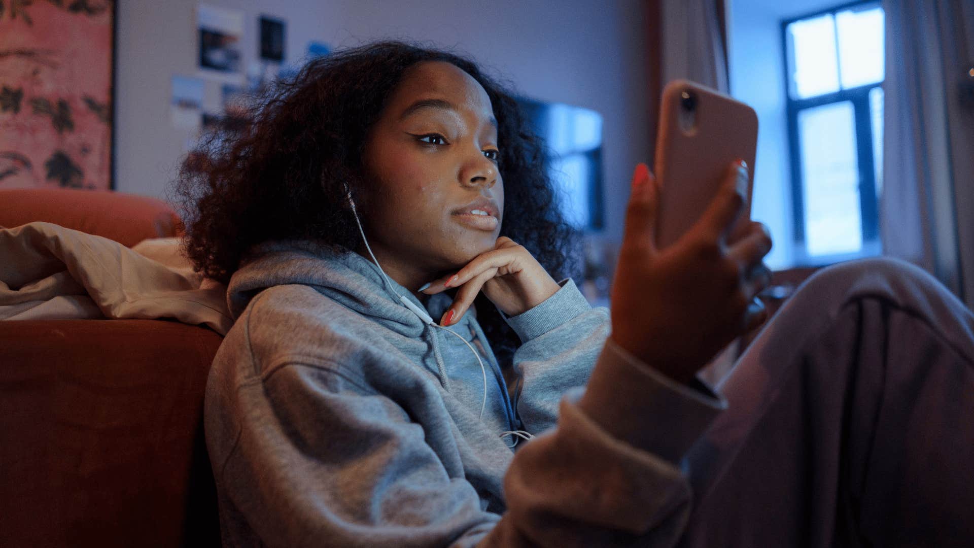 young gen Z woman feeling anxious about technology on her phone