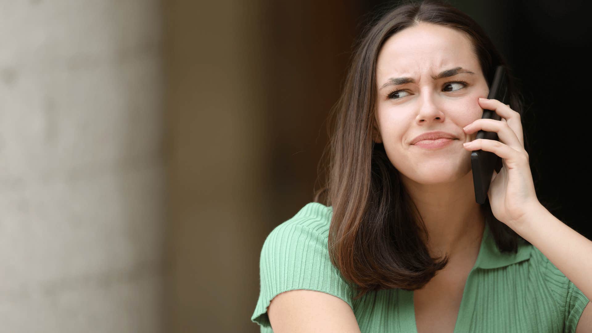 woman in green shirt annoyed on phone as she says don't let it go to your head