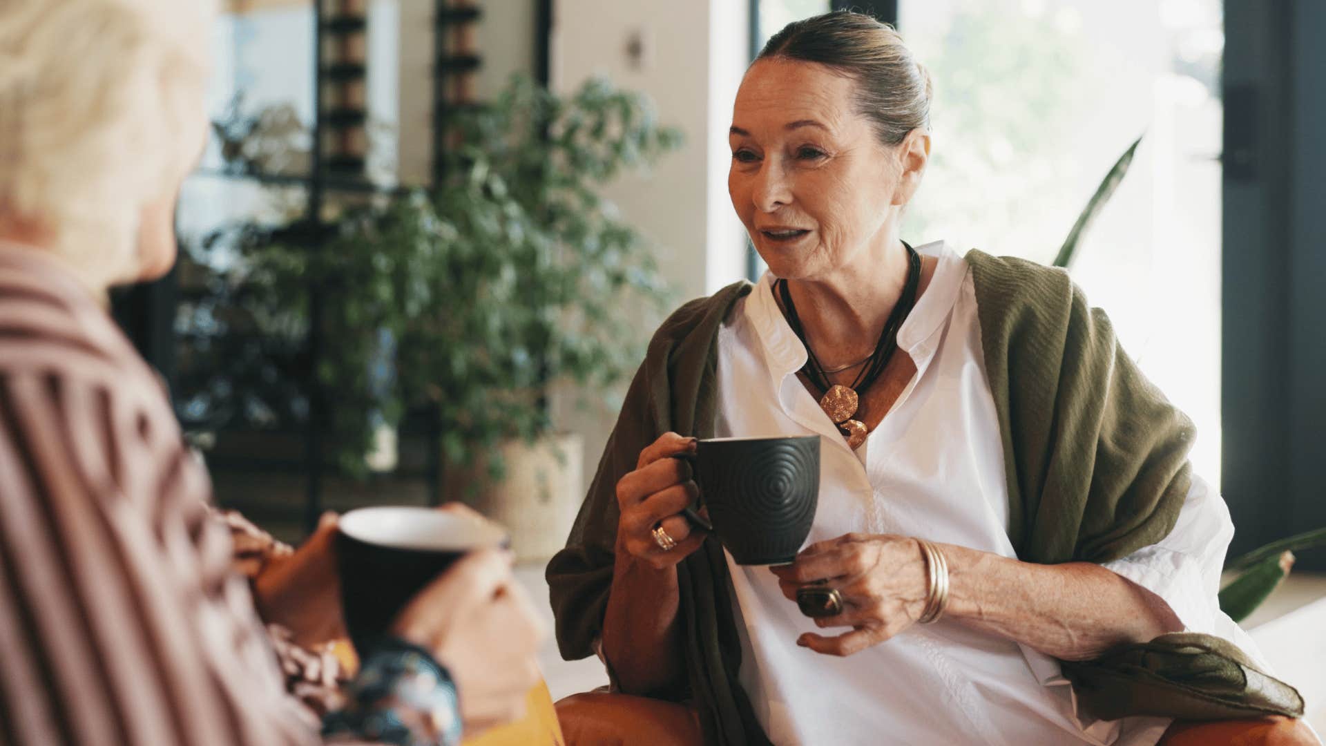 woman in green cardigan telling friend i could never do something like that over tea 