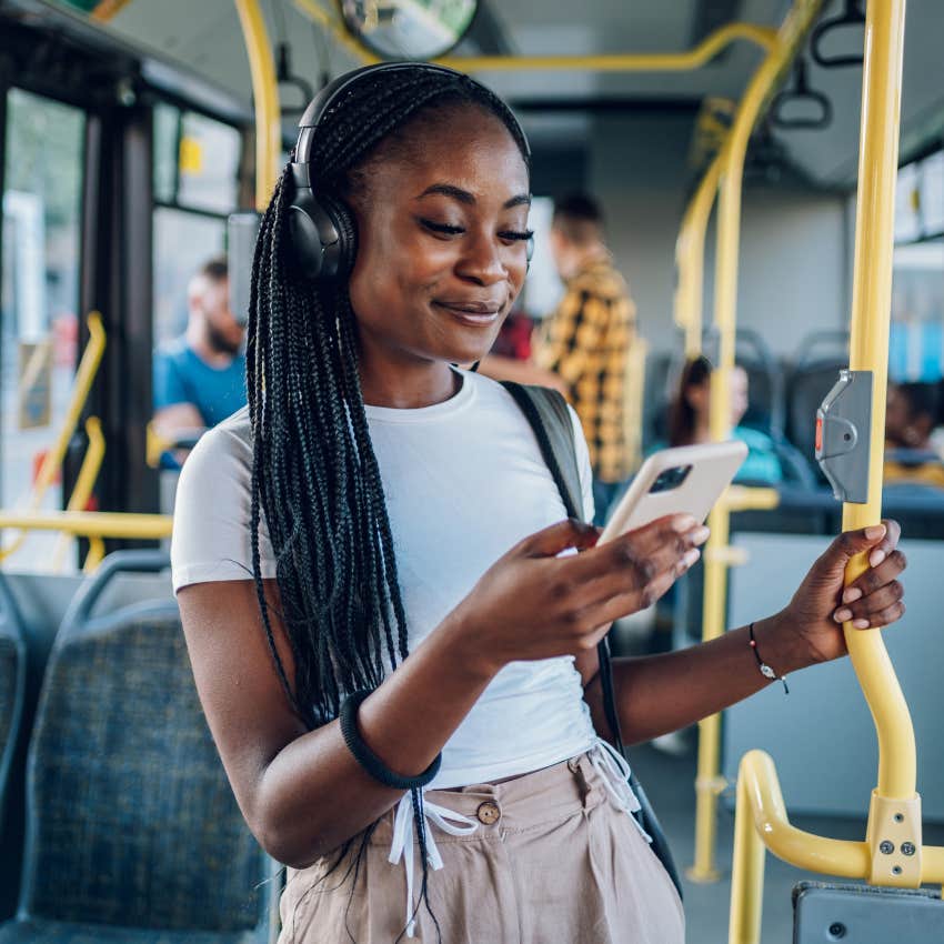 Woman wearing headphones while running errands in public.