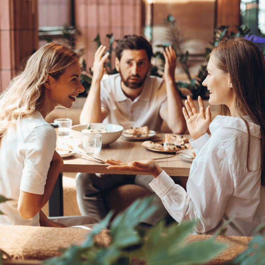 frustrated man watching two women story-top one another