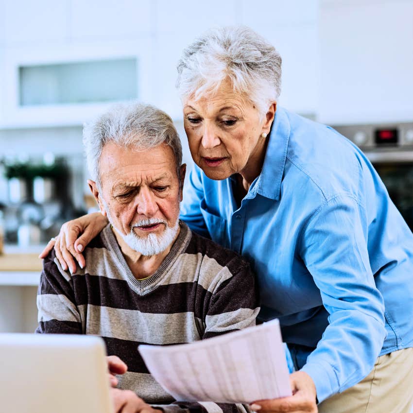 annoyed boomer couple keeping track of passwords on paper