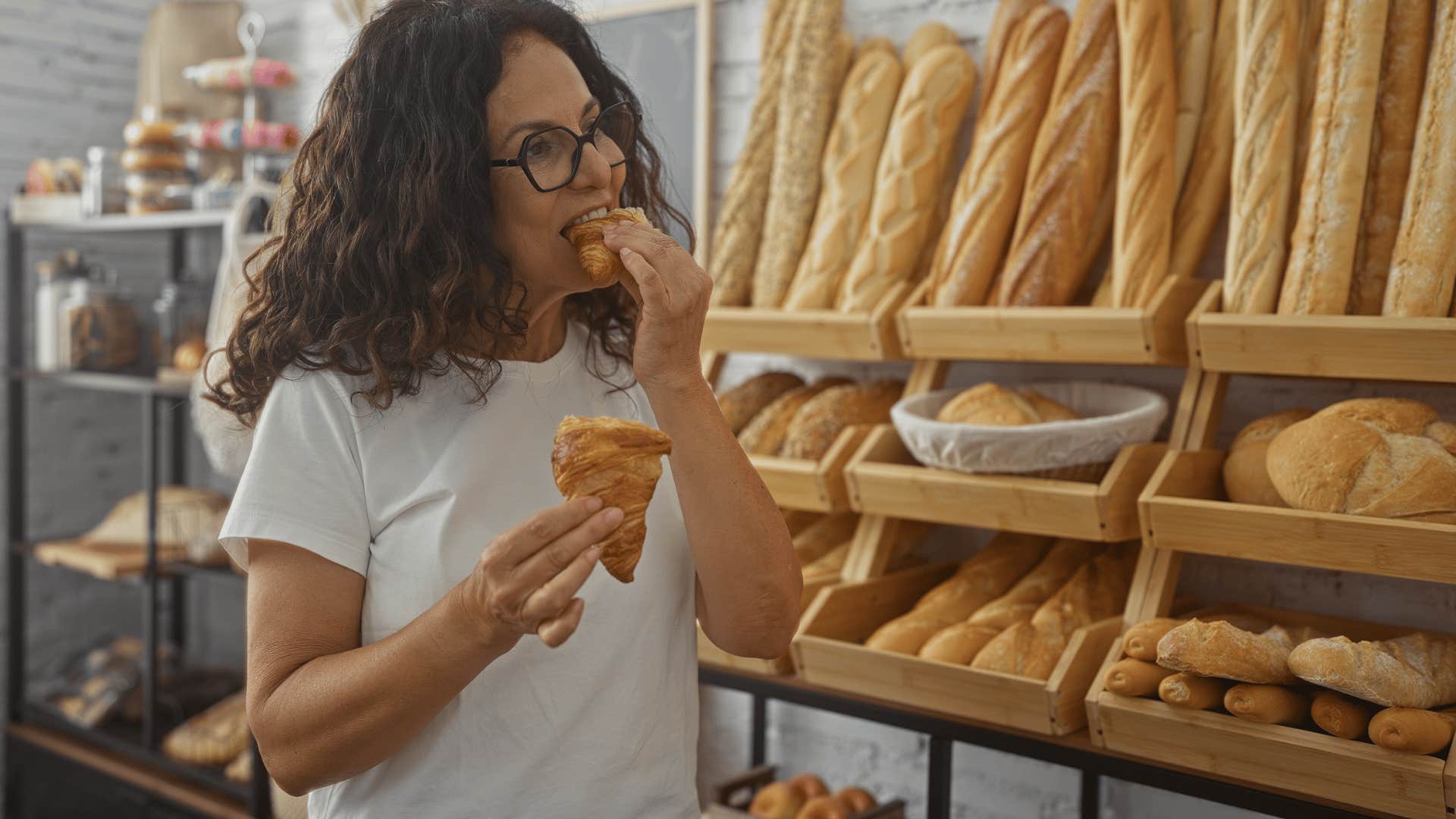 woman eating as she pleases taking a bite of bread