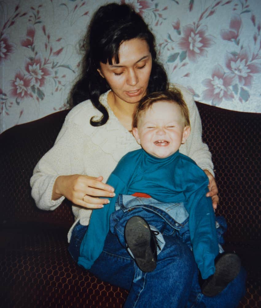 Self-sacrificing Gen X mom in the late 90s holds her baby boy 