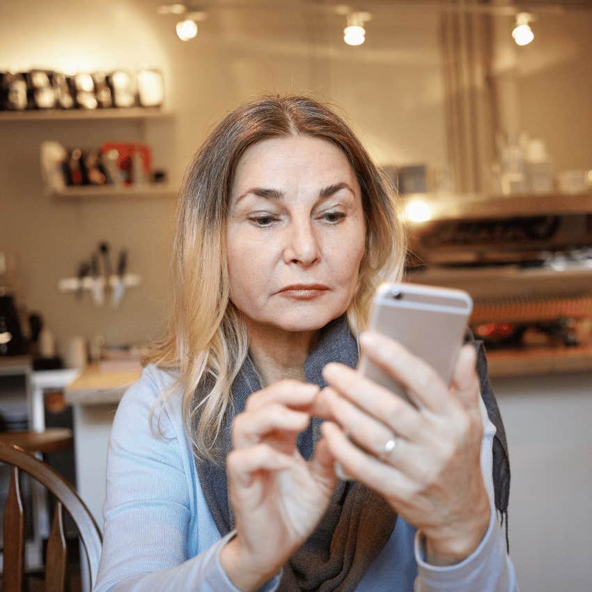Gen-X woman scrolling online on her phone
