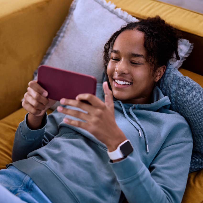 Gen Z woman using streaming services on her phone