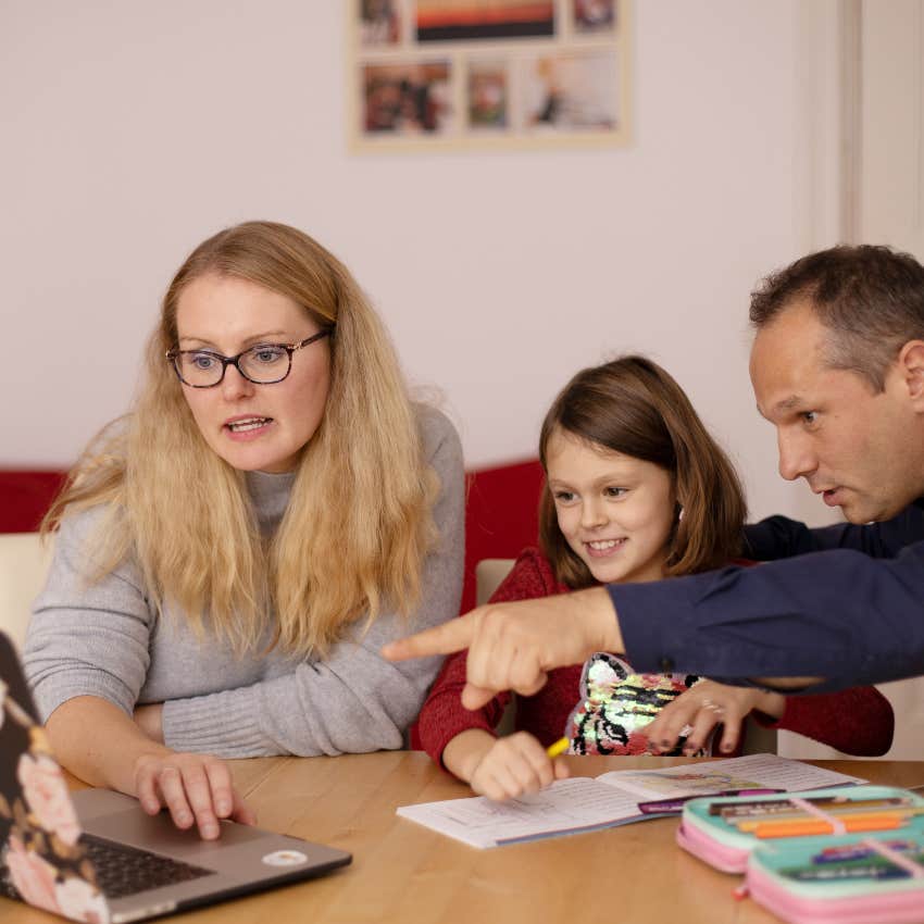 little girl relying on her parents to help her with the computer