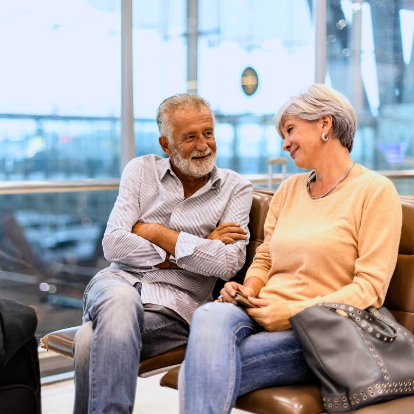 boomers couples dressed up at the airport talking while waiting to board