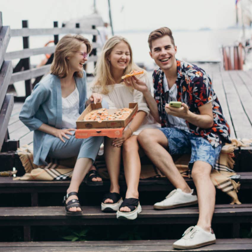 millennial friends spending time together eating food outside