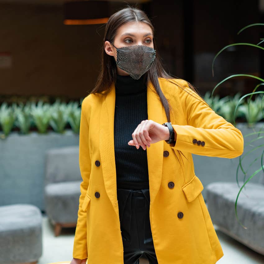 millennial woman at the airport checking watch for the time