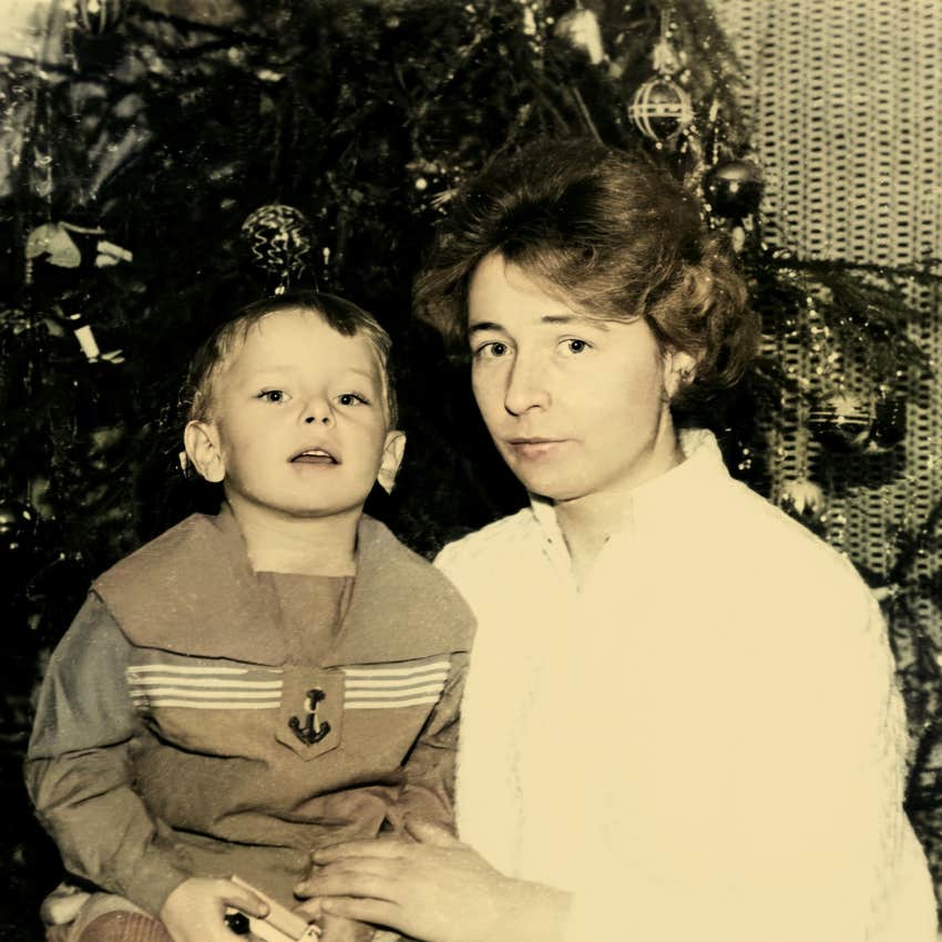 boomer mother posing with child running her home
