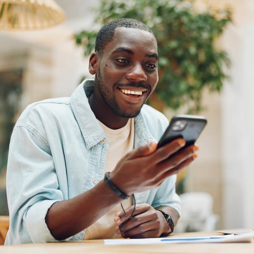 gen z man investing his money using his unsecure phone 