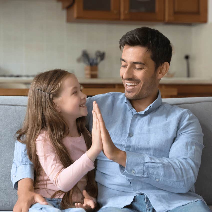 dad with high moral standards high fiving his young daughter 