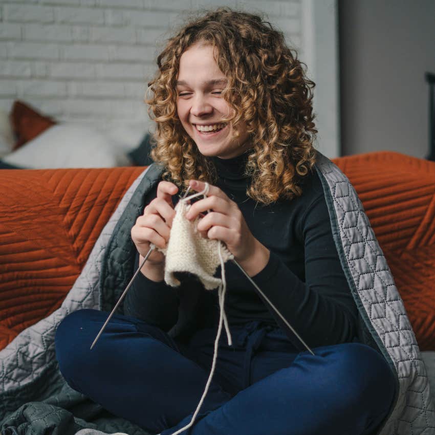 woman who likes a small circle and staying home finding joy in her cozy knitting hobby