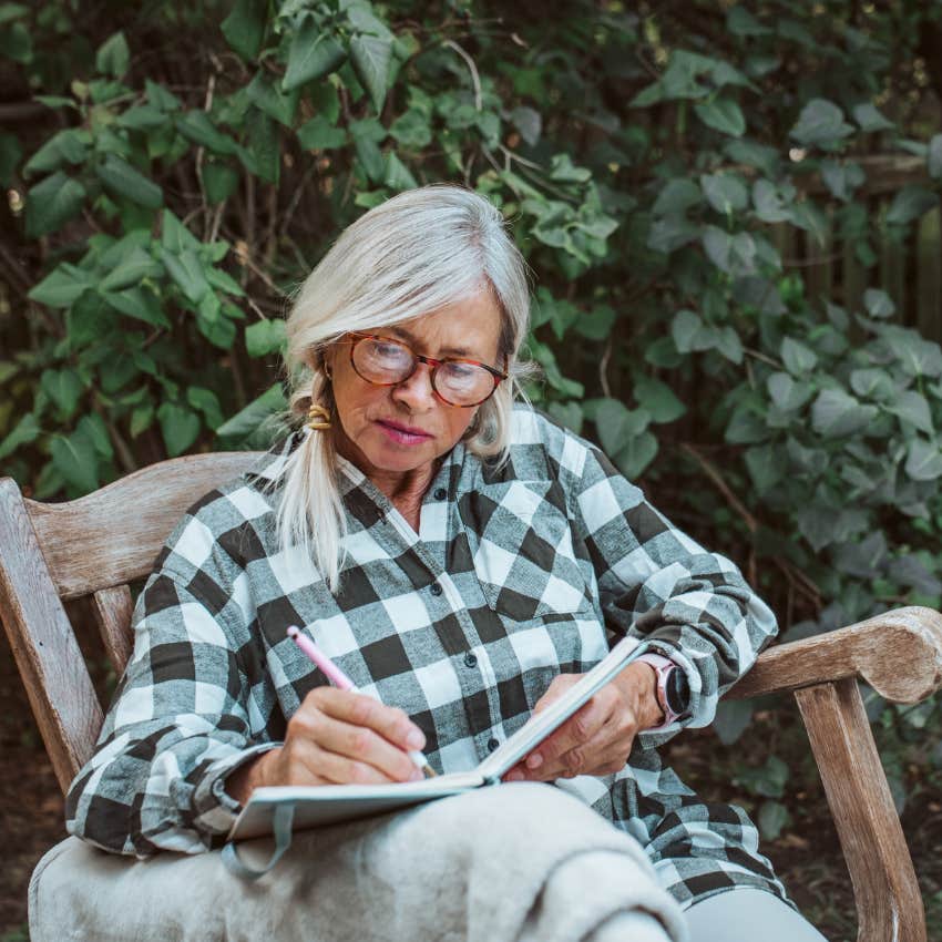 high-strung woman journaling in her backyard to calm down fast