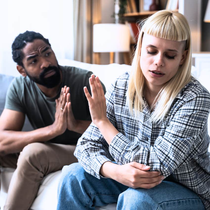 Woman saying "let's just drop it" to her emotional partner.