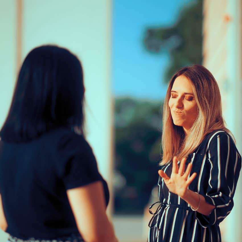 insulted woman speaking to rude friend