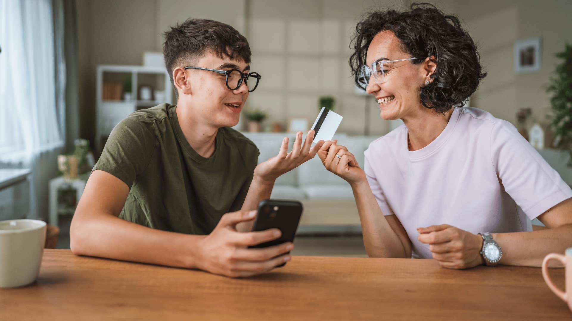 mom letting her teen son borrow her credit card