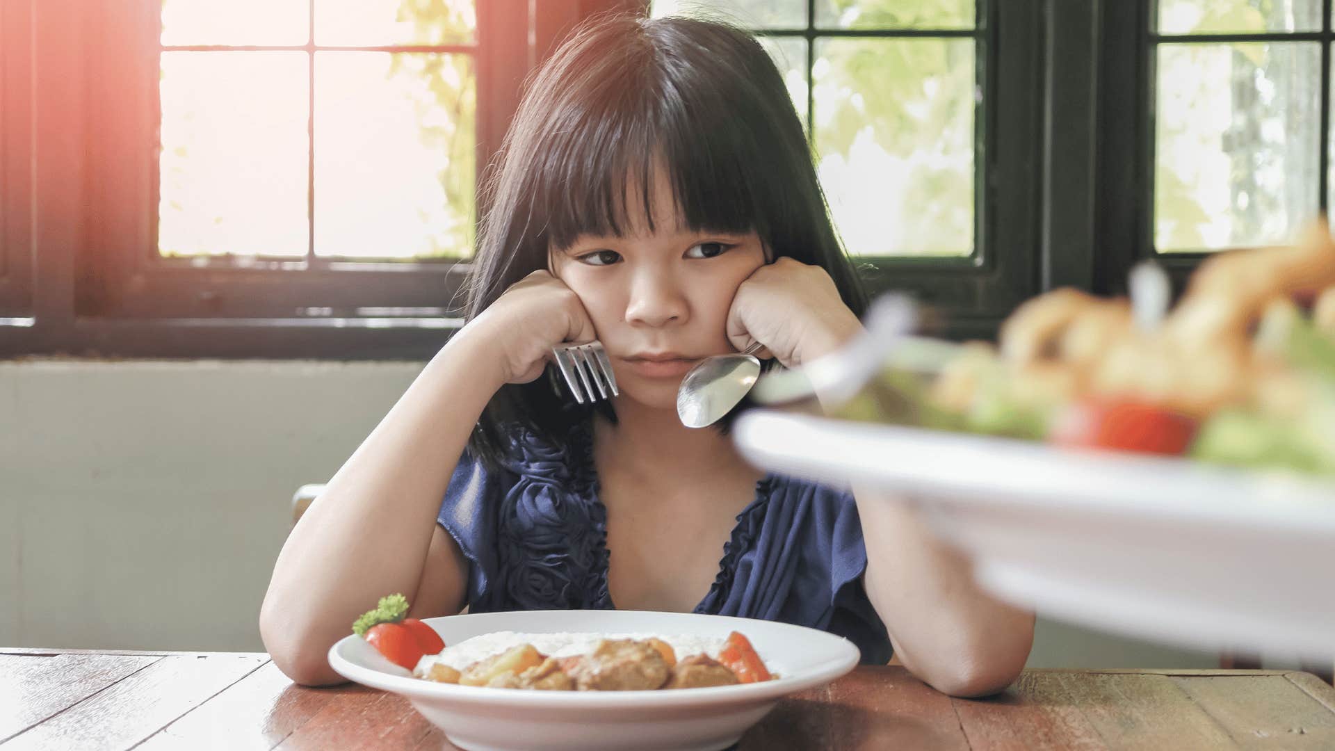 little girl not eating her food because she doesn't like it