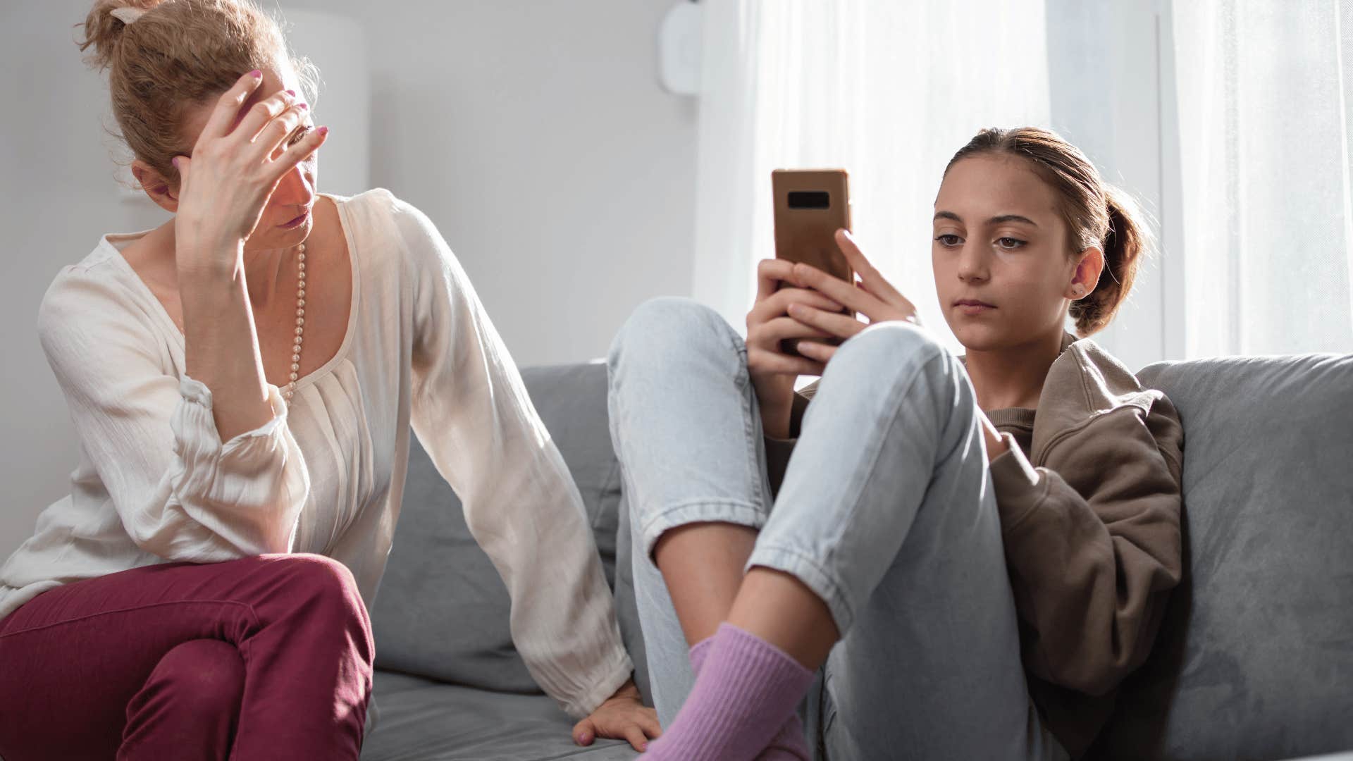 teenager on the phone telling upset mom it's your job