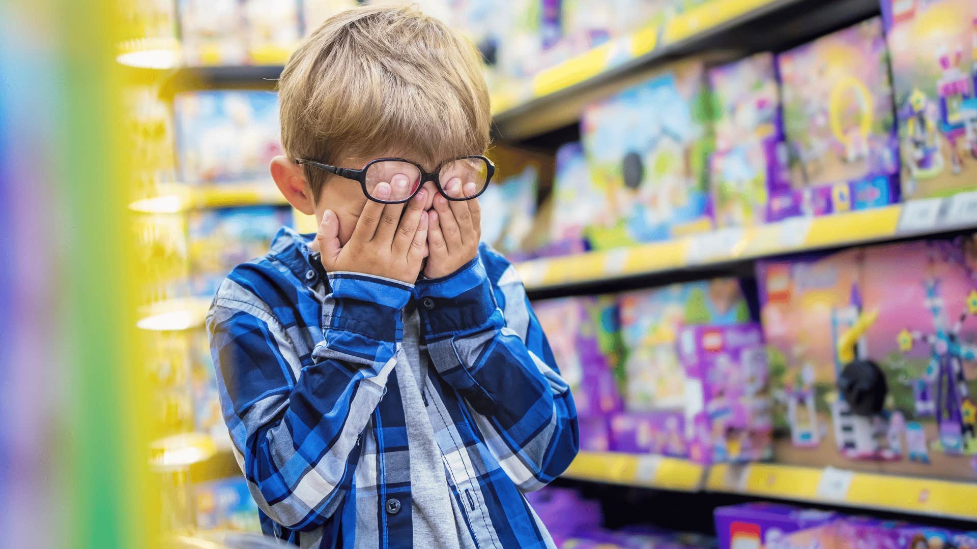 spoiled kid upset in a toy store complaining