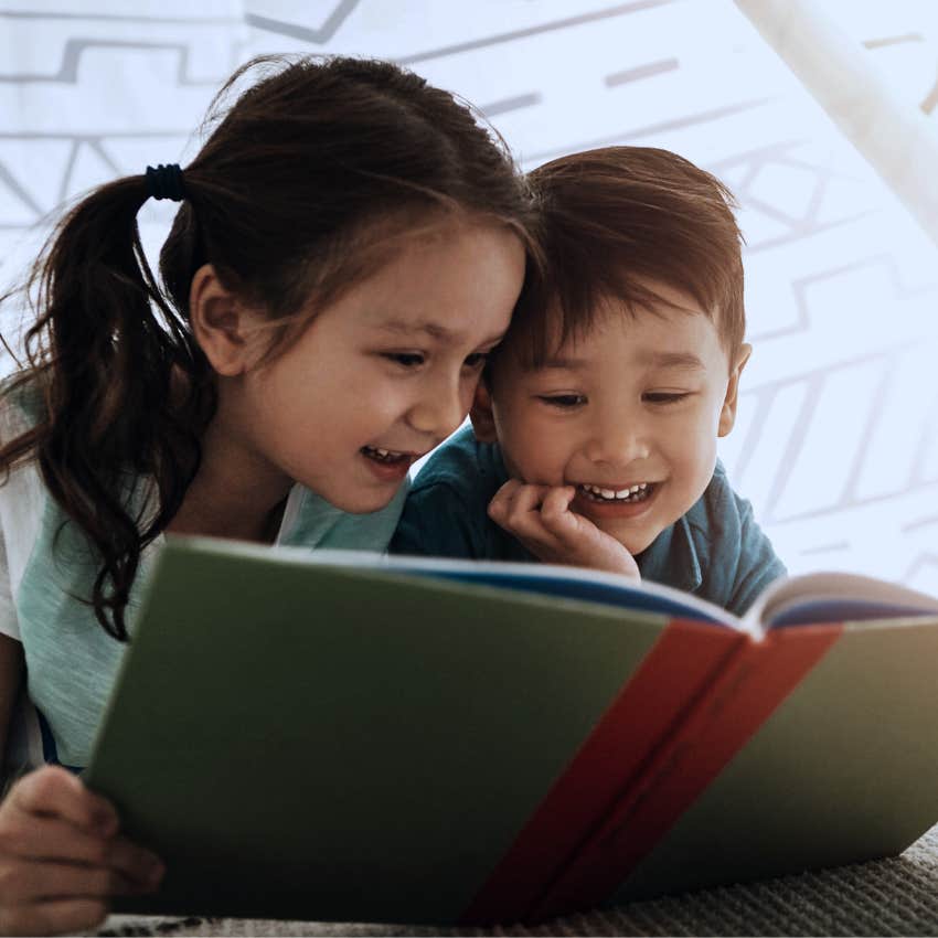 little kids reading books together