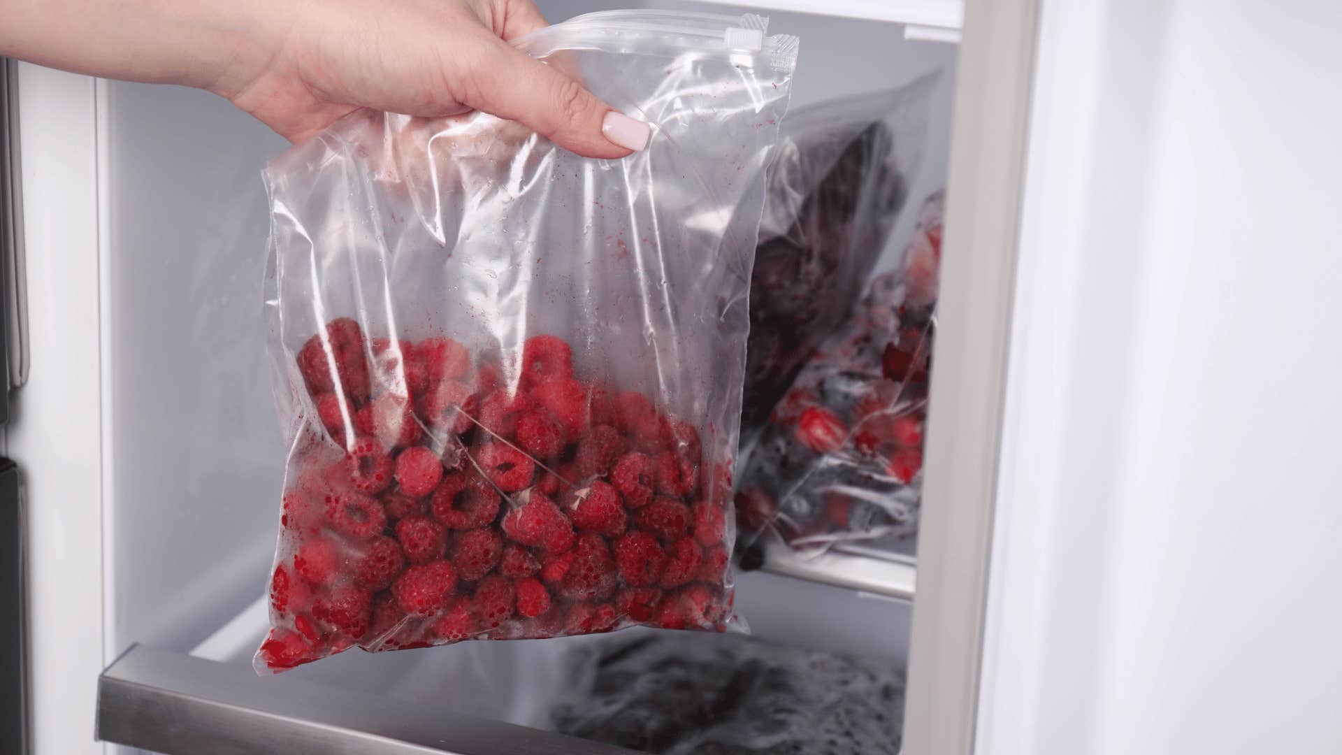 woman freezing berries before they go bad