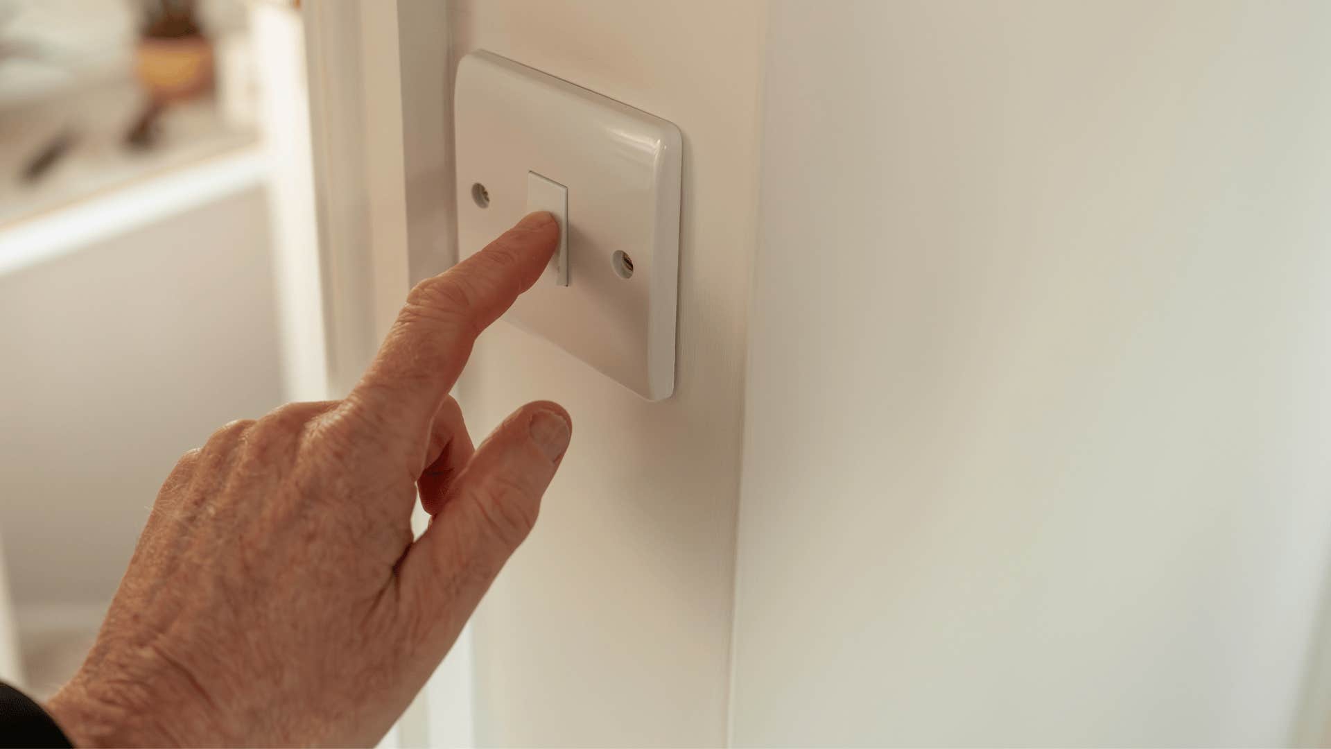 man turning off lights and unplugging appliances 