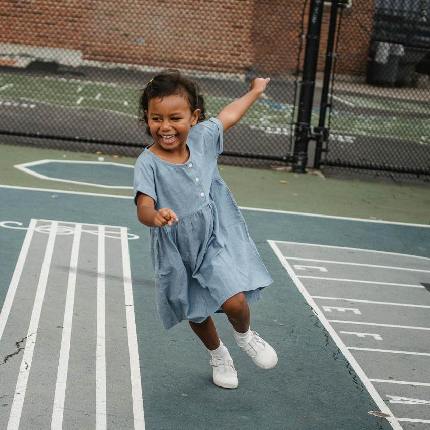 independent little girl running around on her own