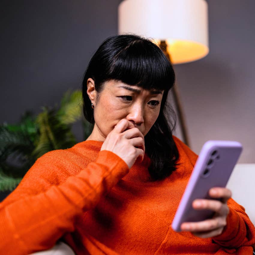 woman who doesn't trust easily looking at her phone