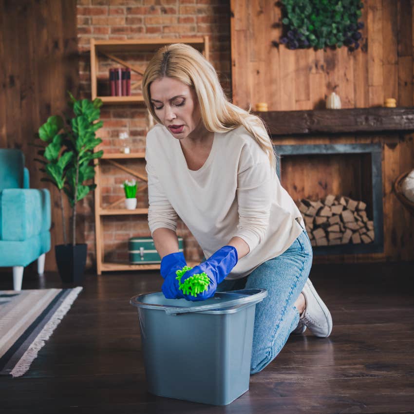 woman deep cleaning the floor because she feels guilty for resting