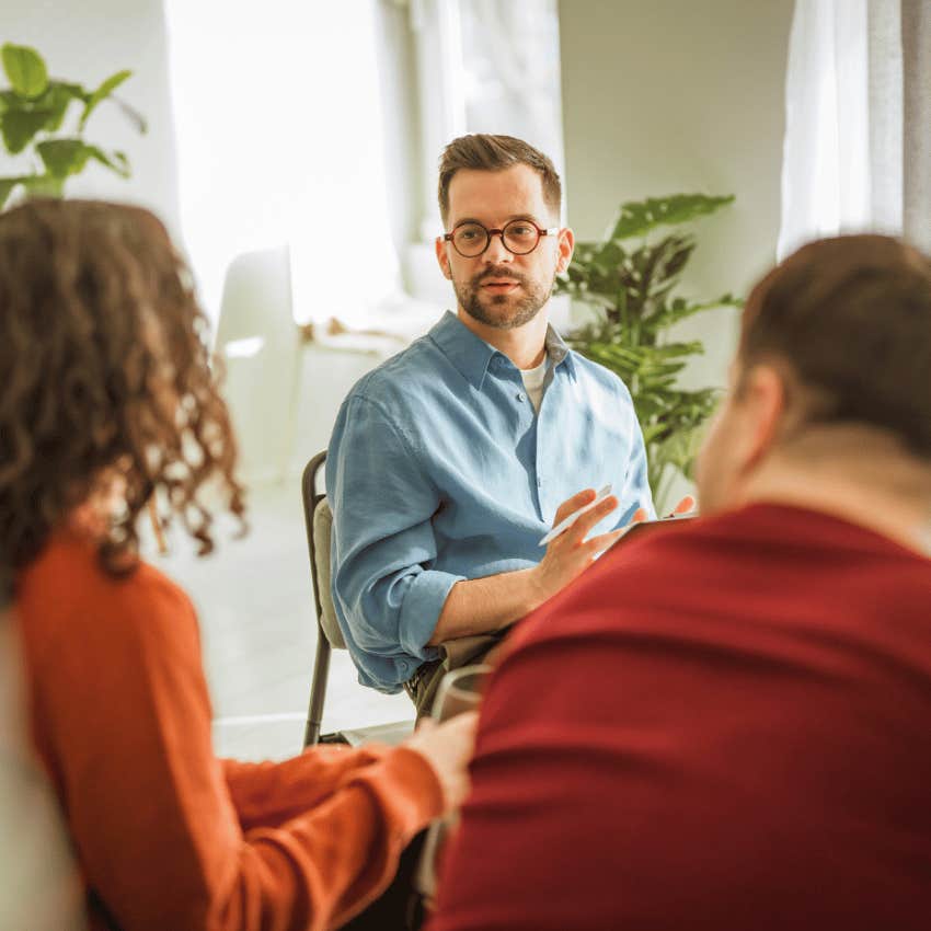 male therapist facing couple during counseling