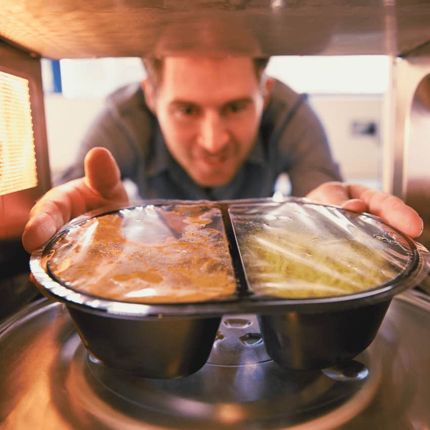 man placing Swanson's TV Dinners into a microwave