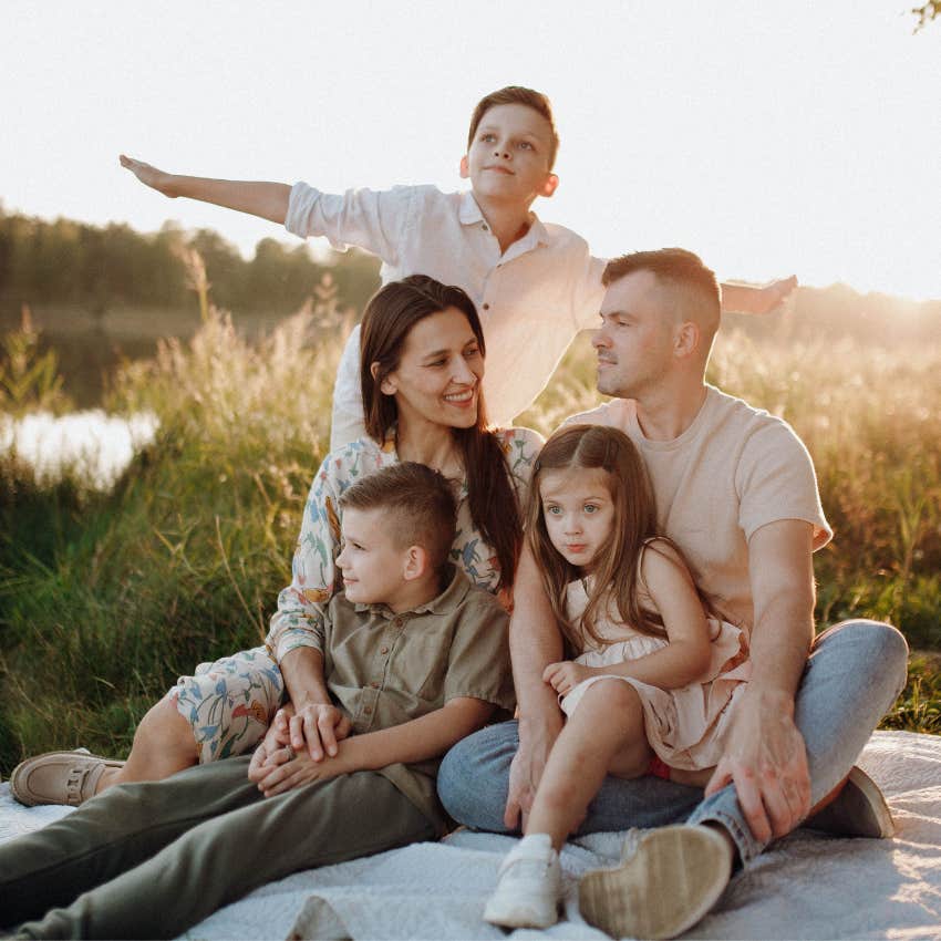 dad spending quality time with his wife and children on a picnic