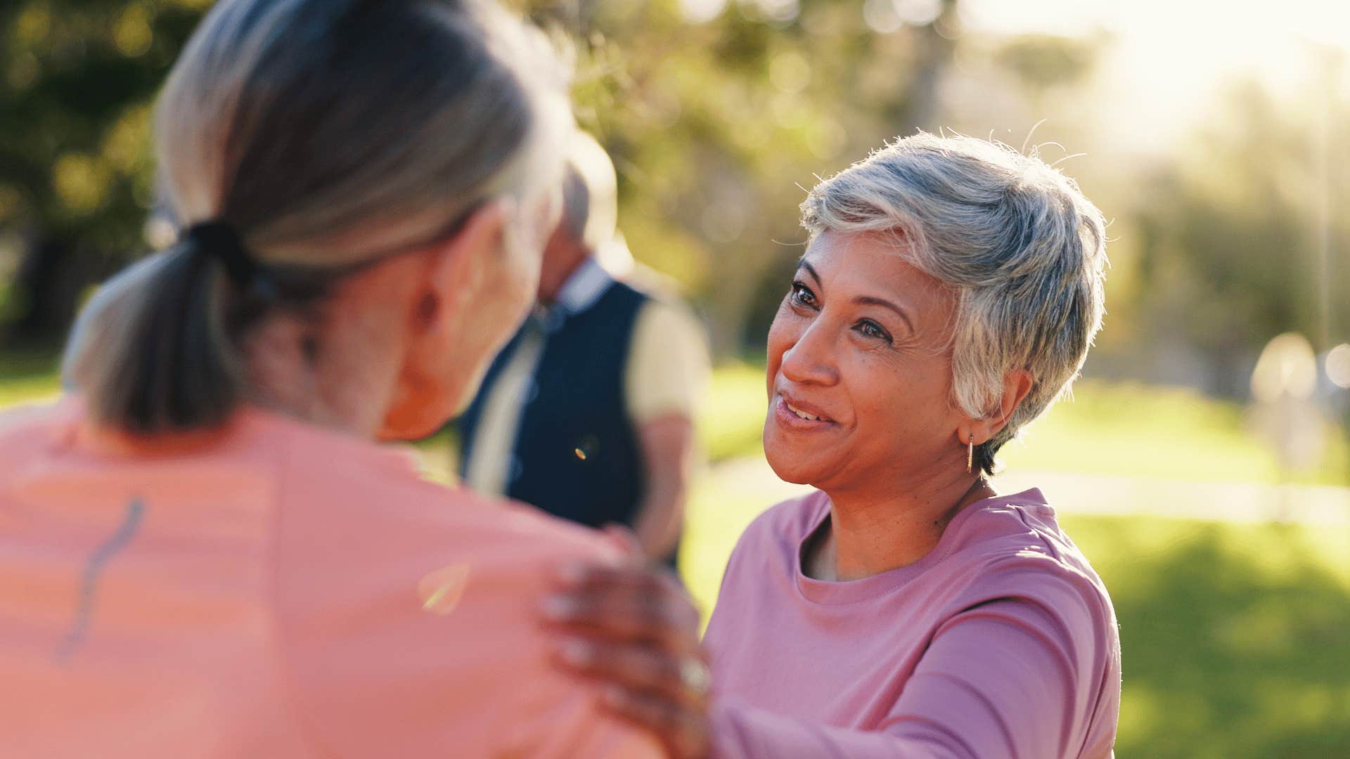 older woman comforting friend to include her
