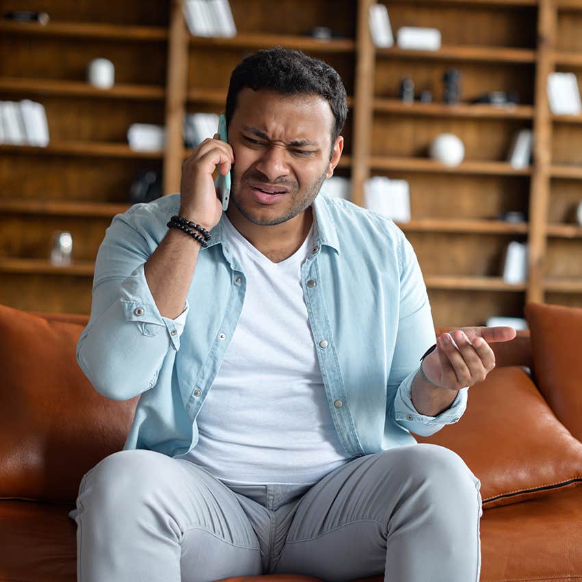 man getting defensive while on the phone