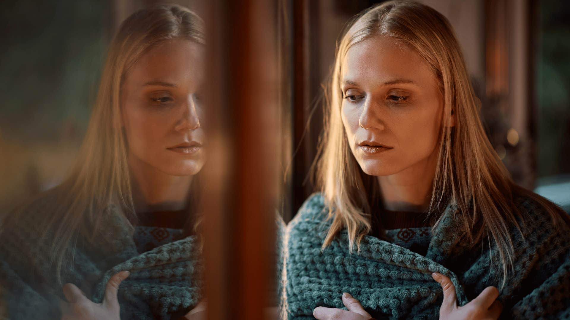woman staring out the window struggling to enjoy the moment