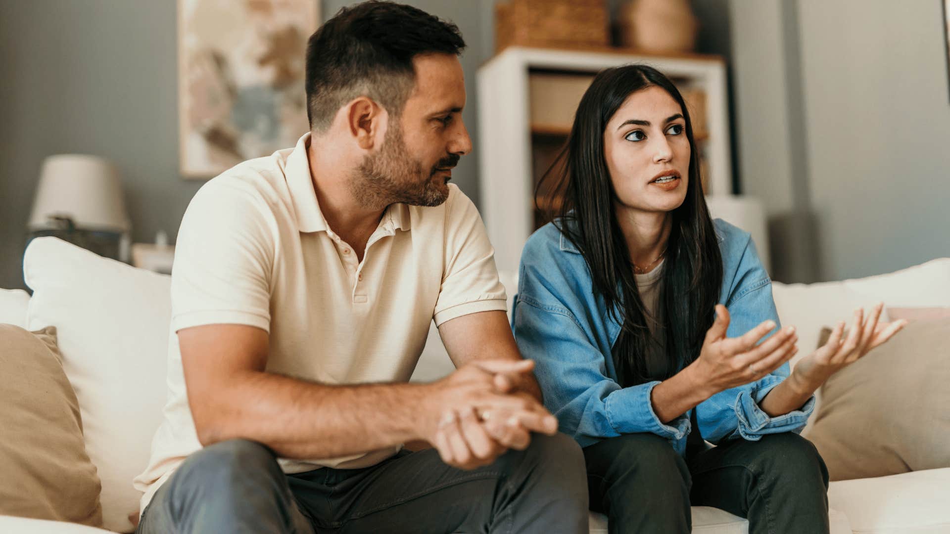 complex thinking woman arguing with husband on couch