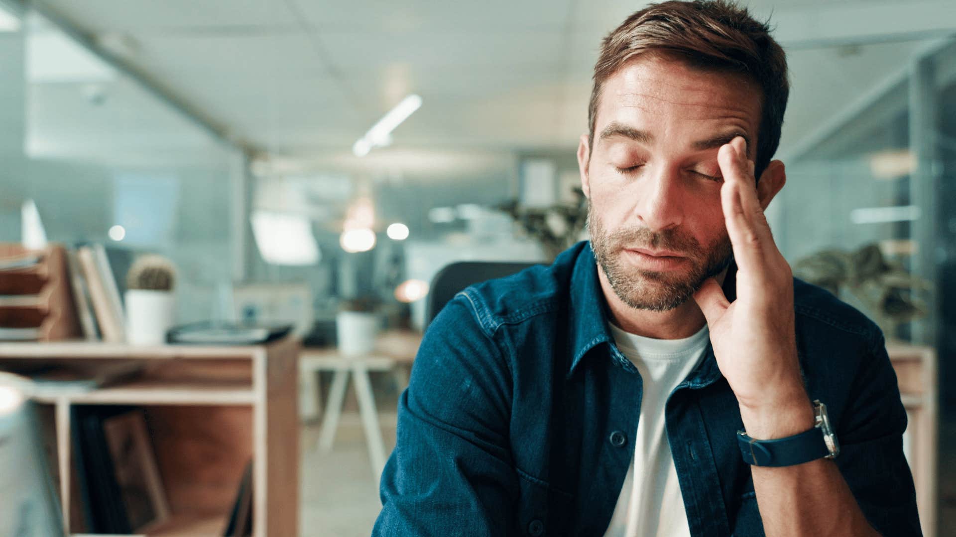 man annoyed rubbing temple as he thinks can i catch a break