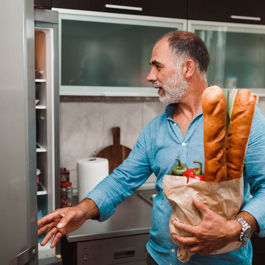 man putting the groceries away