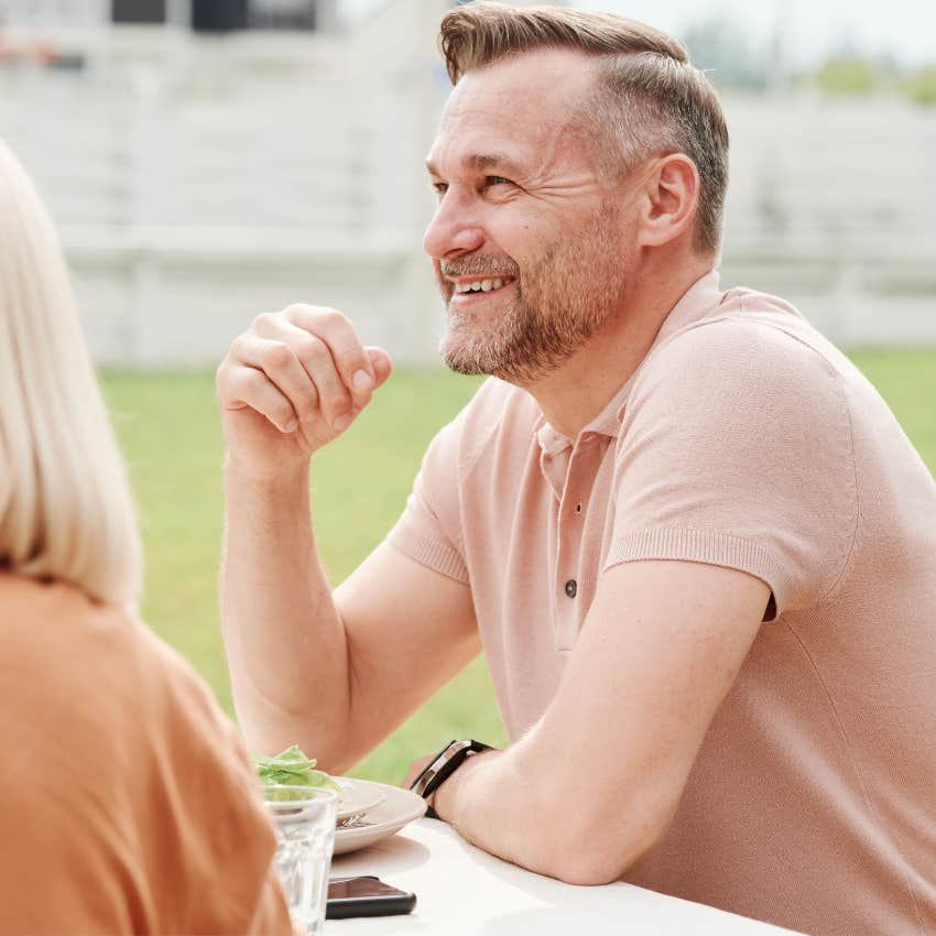 Hopeful man looking relaxed while talking about an uncertain future with a friend