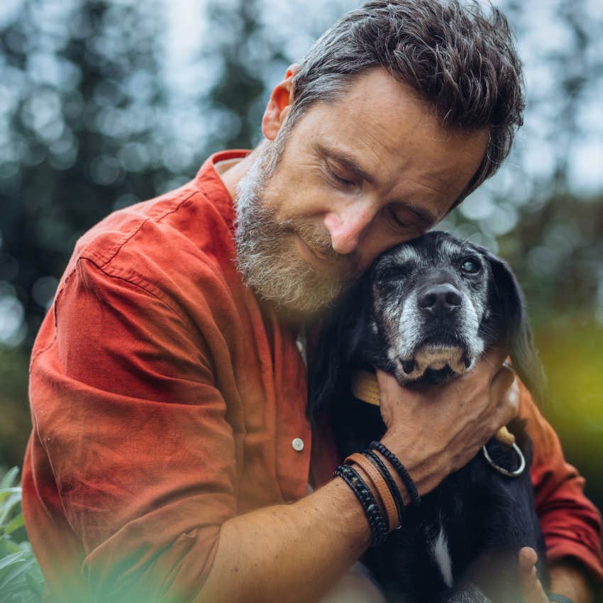 intellectually curious man hugging senior dog remembering lesson that you have to live and learn