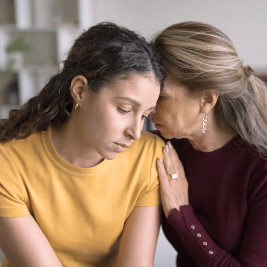 older mom comforting daughter