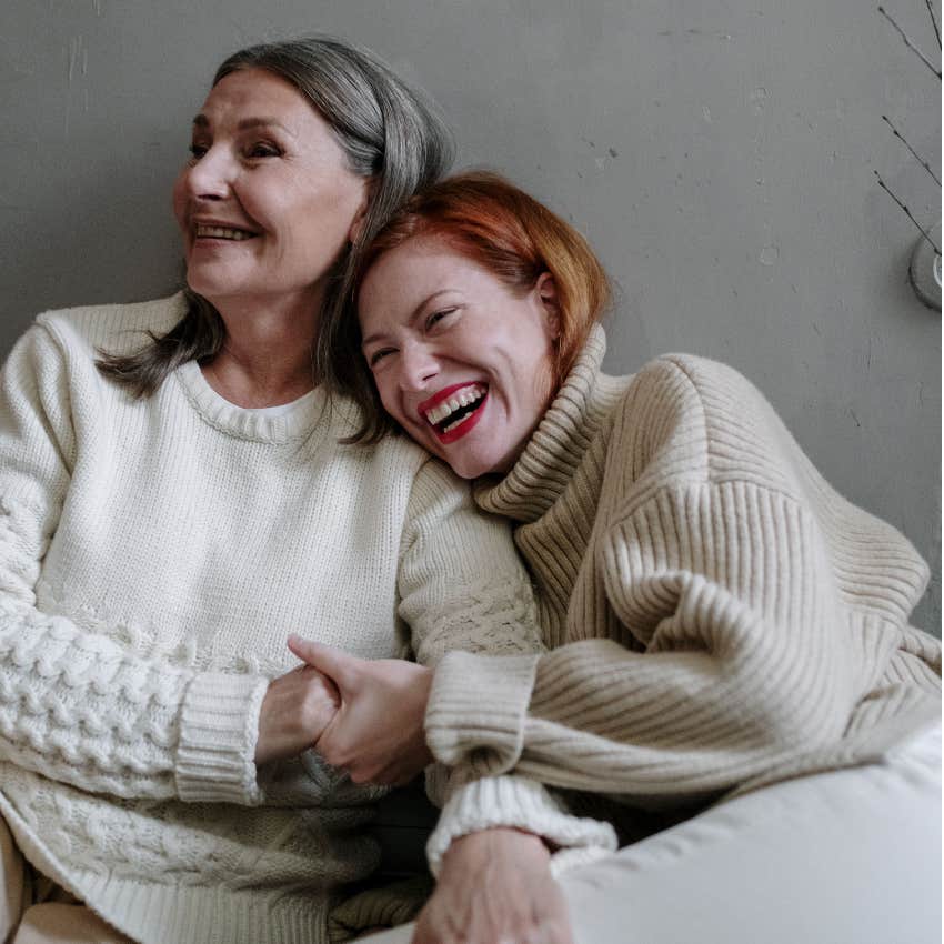 adult woman and her mom laughing together