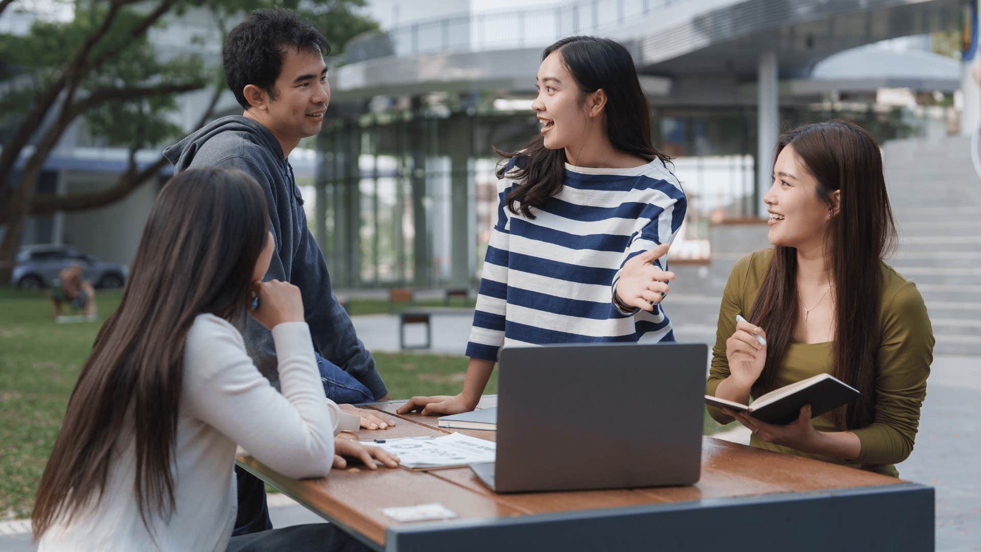 woman telling classmates during group meetup it's fine i'm used to it as she takes on lead