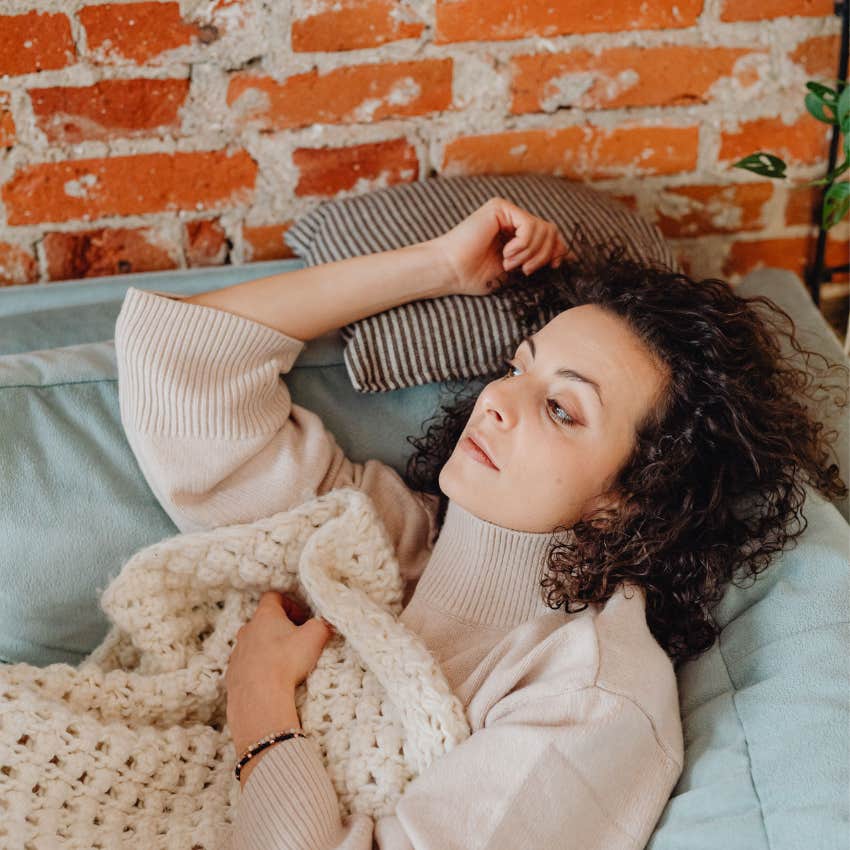 woman relaxing enjoying a quiet moment of comfort at home