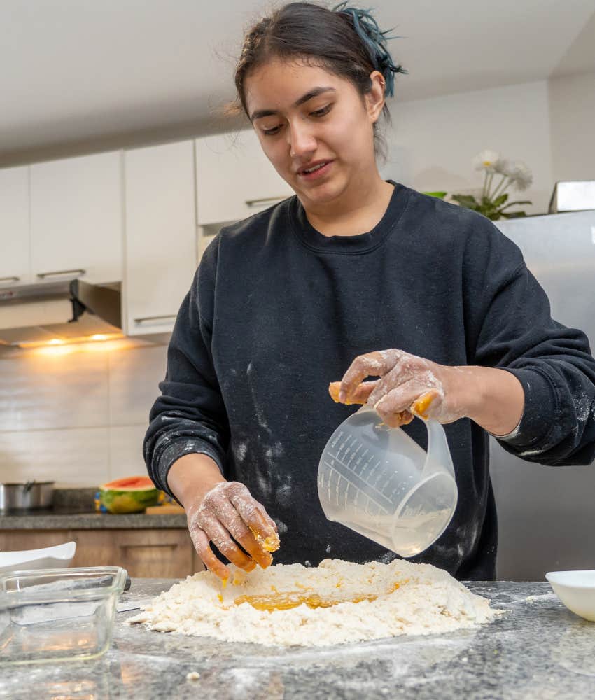 woman who is truly happy baking at home 
