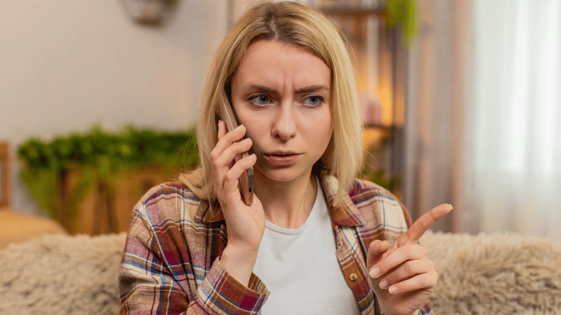 woman with blonde hair arguing on the phone saying why should i text first